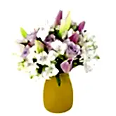 pastel colours flower arrangement in orange vase